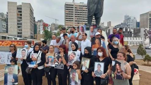 Families of the Aug. 4 blast victims gather in front of the port, 25 months after the tragedy