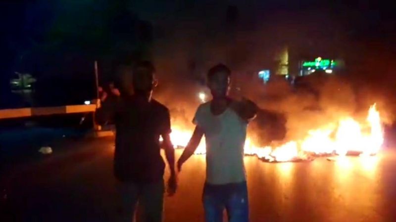 Protesters block the road around Mikati's home in Tripoli