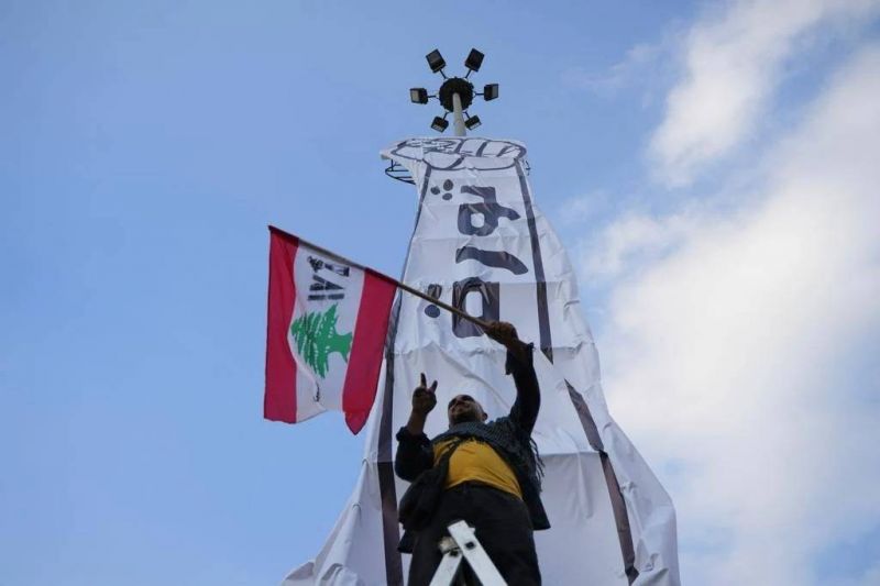 Three years on: Protesters install the 'fist of the revolution' in Beirut's Martyrs' Square