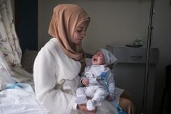 Two-month-old Abdallah who has cholera with his mother at Dr. Abdullah al-Rassi Government Hospital in Halba. (Credit: João Sousa/L'Orient Today)