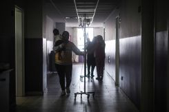 A woman cradles her infant son with cholera in the hallways of Dr. Abdullah al-Rassi Government Hospital in Halba. (Credit: João Sousa/L'Orient Today)