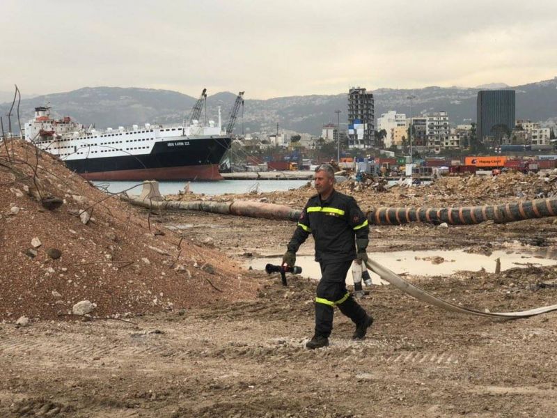 Civil Defense extinguishes fire inside an abandoned ship at Beirut port