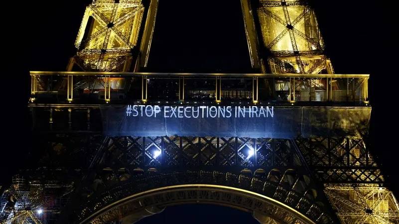 Paris' Eiffel Tower lights up with slogans in solidarity with Iranians