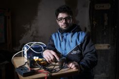 Muhammad al-Sabsabi, 25, used found materials to build his own wind turbine with the help of local welders, YouTube videos and books. Here he tinkers with the prototype for an electric arghileh coal in his home in Bebnine, Akkar governorate. (Credit: João Sousa/L’Orient Today)