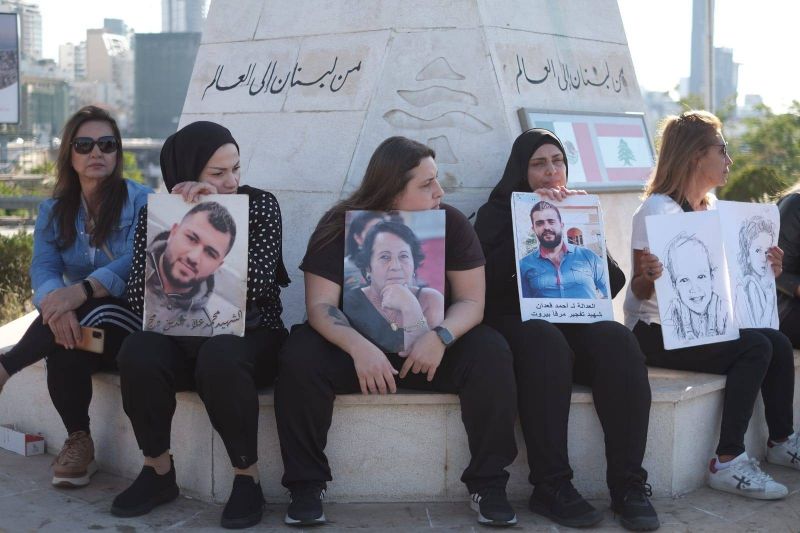 Families of the victims hold a sit-in to commemorate August 4