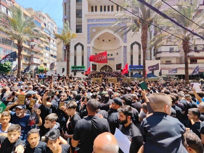 Quran in hand, Hezbollah supporters demonstrate in Beirut's southern suburbs