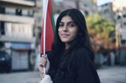 Ghada portant un drapeau palestinien lors d'une manifestation dans la banlieue sud de Beyrouth, le 20 octobre 2023. Photo João Sousa
