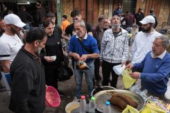 Residents of Beb al-Ramel gather around the vendor selling sharab al-sous. (Credit: João Sousa/L'Orient Today)