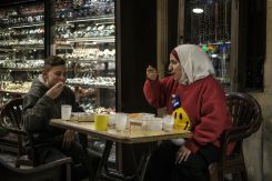 A jewelry shop supervisor and kid barber share their iftars as they keep their shops open into suhour hours. (Credit: João Sousa/L'Orient Today)