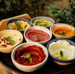 A tray of seven different dips served at Beiruti. (Courtesy of Beiruti/@beirutiofficial via Instagram)