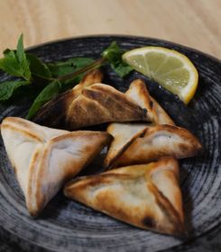 Spinach pies served at Beiruti with lemon and mint. (Courtesy of Beiruti/@beirutiofficial via Instagram)