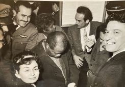 Pictures at the airport welcoming, On Louis's right you can spot Mrs Cecile and on his left, his wife Lucille.