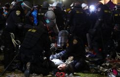 California Highway Patrol (CHP) officers detain a protestor while clearing a pro-Palestinian encampment after dispersal orders were given at the University of California, Los Angeles (UCLA) campus, on May 2, 2024 in Los Angeles, California. (Credit: Mario Tama/AFP)