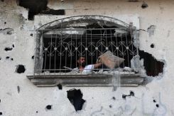 A Palestinian man inspects the damage in his apartment after an Israeli airstrike in Rafah in the southern Gaza Strip on May 22, 2024. (Credit:Eyad al-Baba AFP)