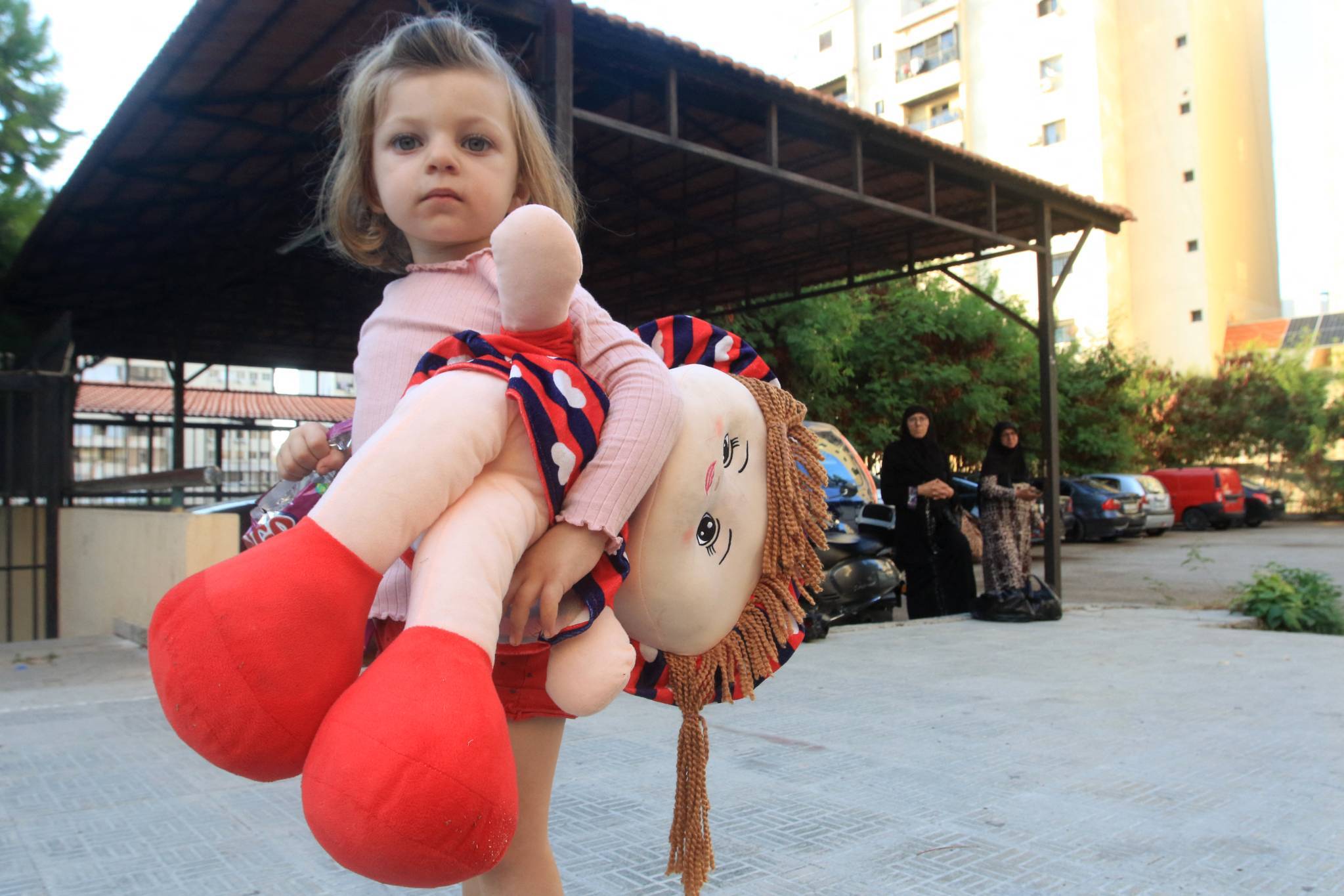 Some families are heading to Saida, like this little girl’s family, who is moving into a school in the city that has been transformed into a shelter. (Credit: Mahmoud Zayyat/AFP)
