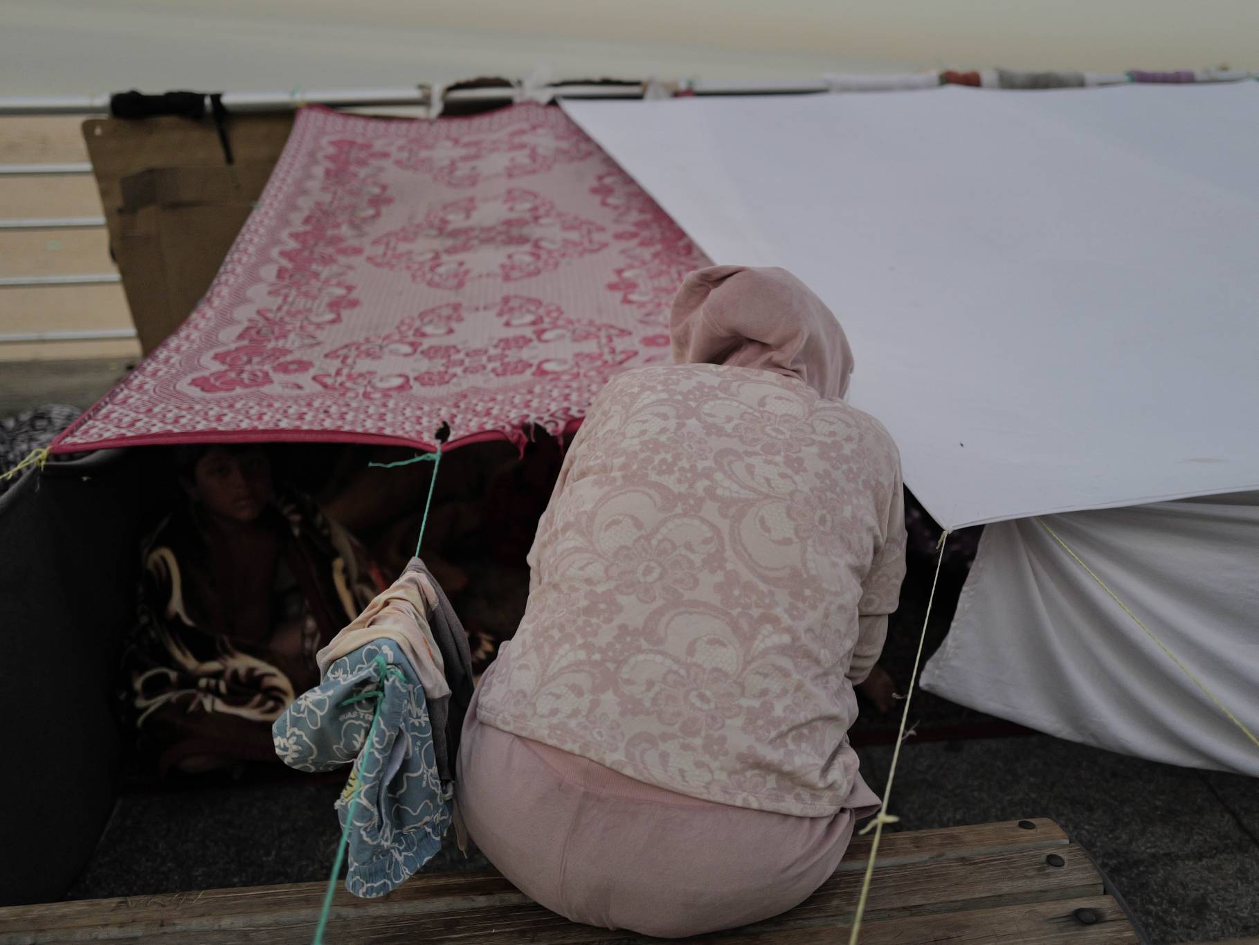 Sous l'une d'elles, Feryal, la cinquantaine, ses enfants et son neveu ont trouvé abri. Ils ont fui en catastrophe le quartier de Haret Hreik dans la banlieue sud de Beyrouth, lourdement bombardé par l'aviation israélienne. « Lors de la guerre de 2006, nous avions loué un logement abordable à Dbayé. Mais aujourd'hui, les loyers sont hors de prix ». Elle espère quand même pouvoir rentrer chez elle. « Si Dieu le veut ». Photo Matthieu Karam