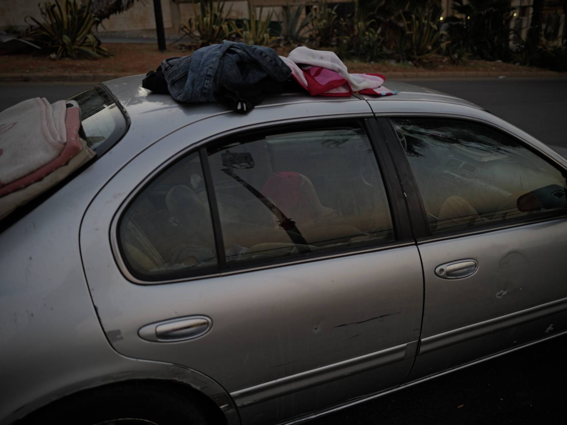 Adults who own cars make sure their children sleep in them, safe from the cold and mosquitoes. (Credit: Matthieu Karam)