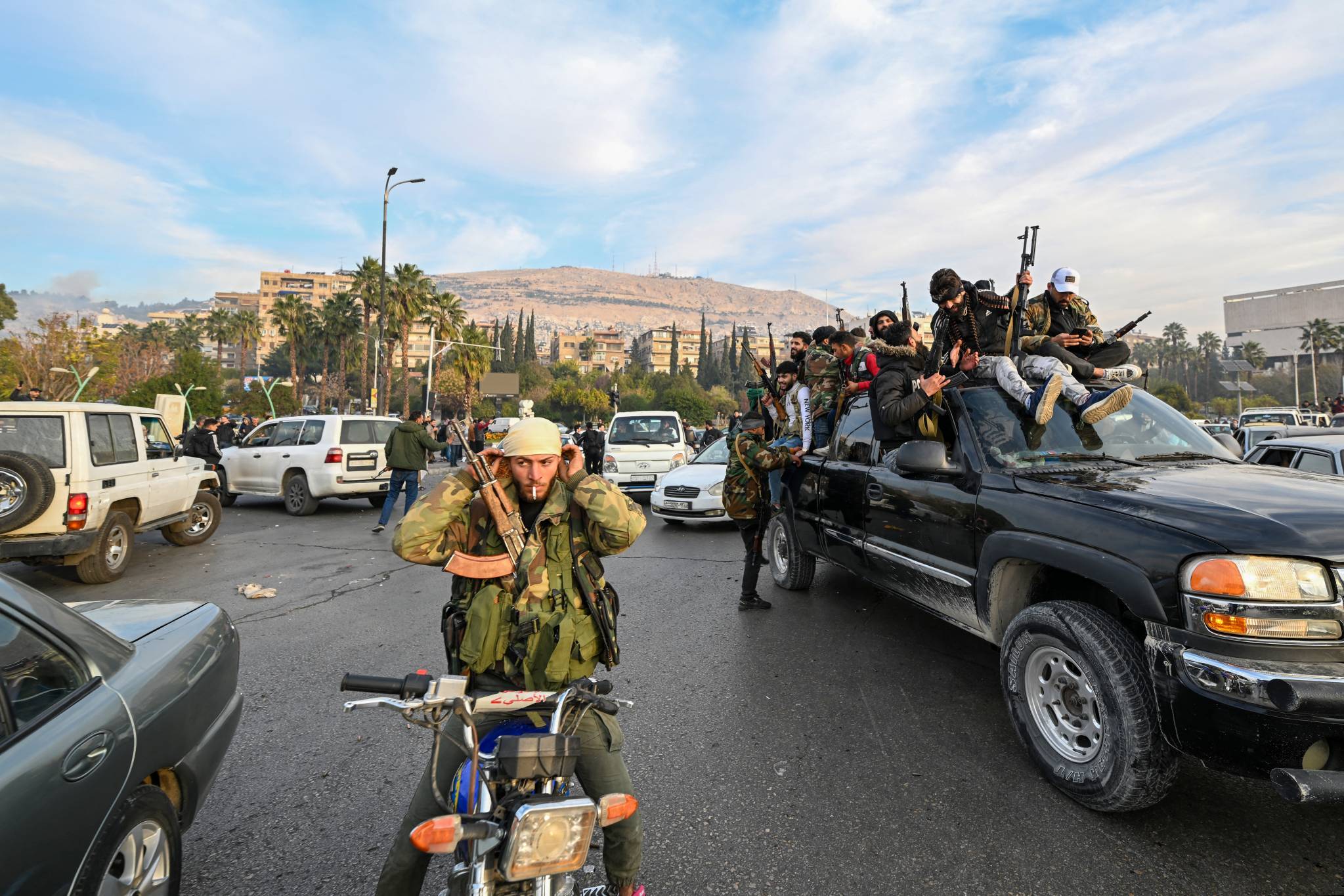Rebel forces arriving at Umayyad Square, Damascus, on the morning of Dec. 8, 2024. A few hours earlier, rebel forces had announced the fall of Bashar al-Assad's regime. (Credit: Louai Beshara/AFP)