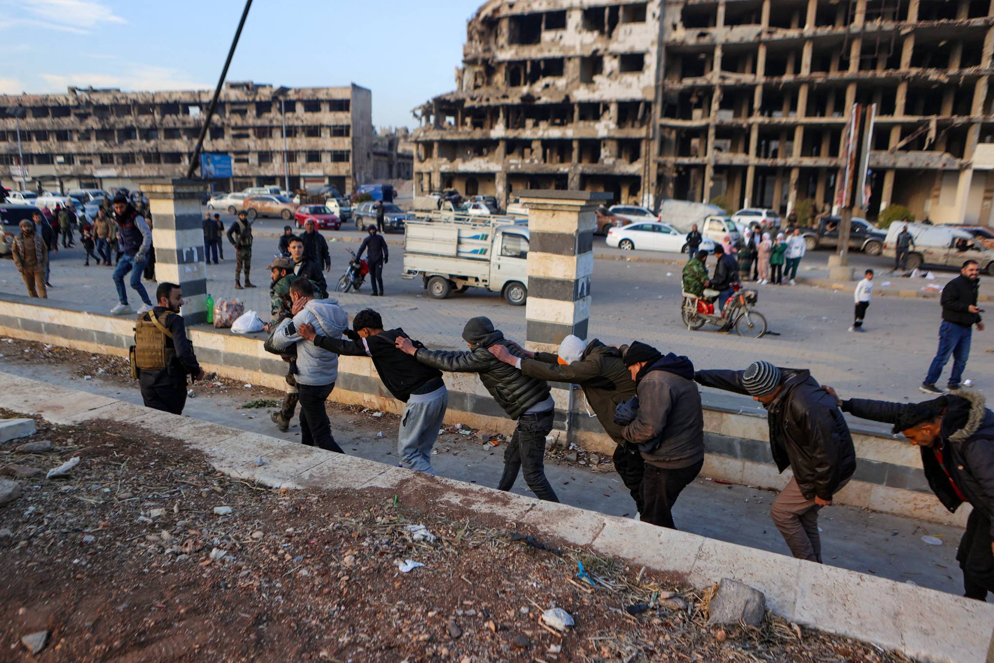 Syrian rebels also showed off members of government forces in civilian clothes in the streets of Homs. (Credit: Aaref Watad/AFP)