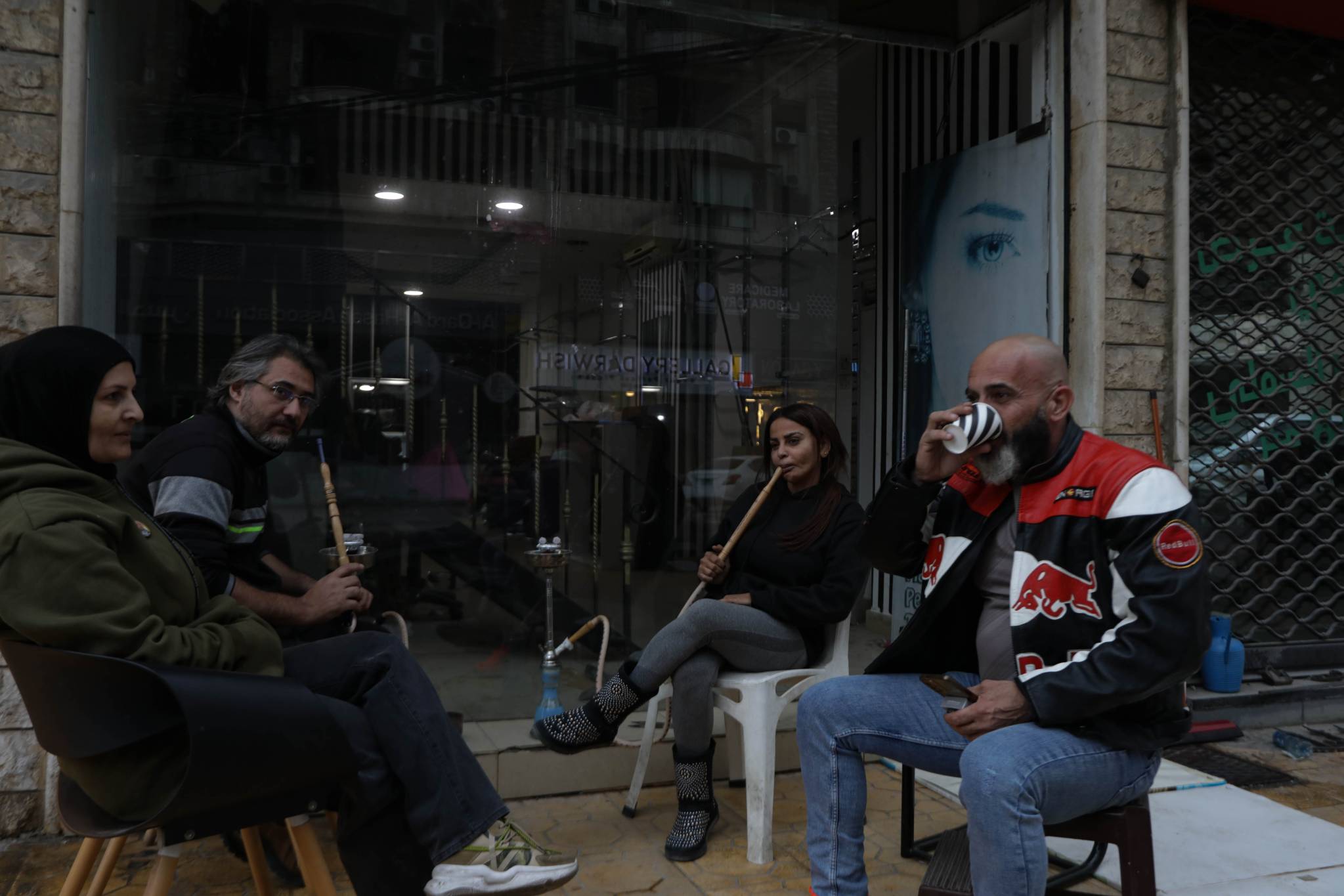 Even on the side of the road, next to empty shops that were once filled with people, friends gather to smoke arguileh and drink coffee, braving the increasingly cold winter weather. (Credit: Nicholas Frakes/OT)