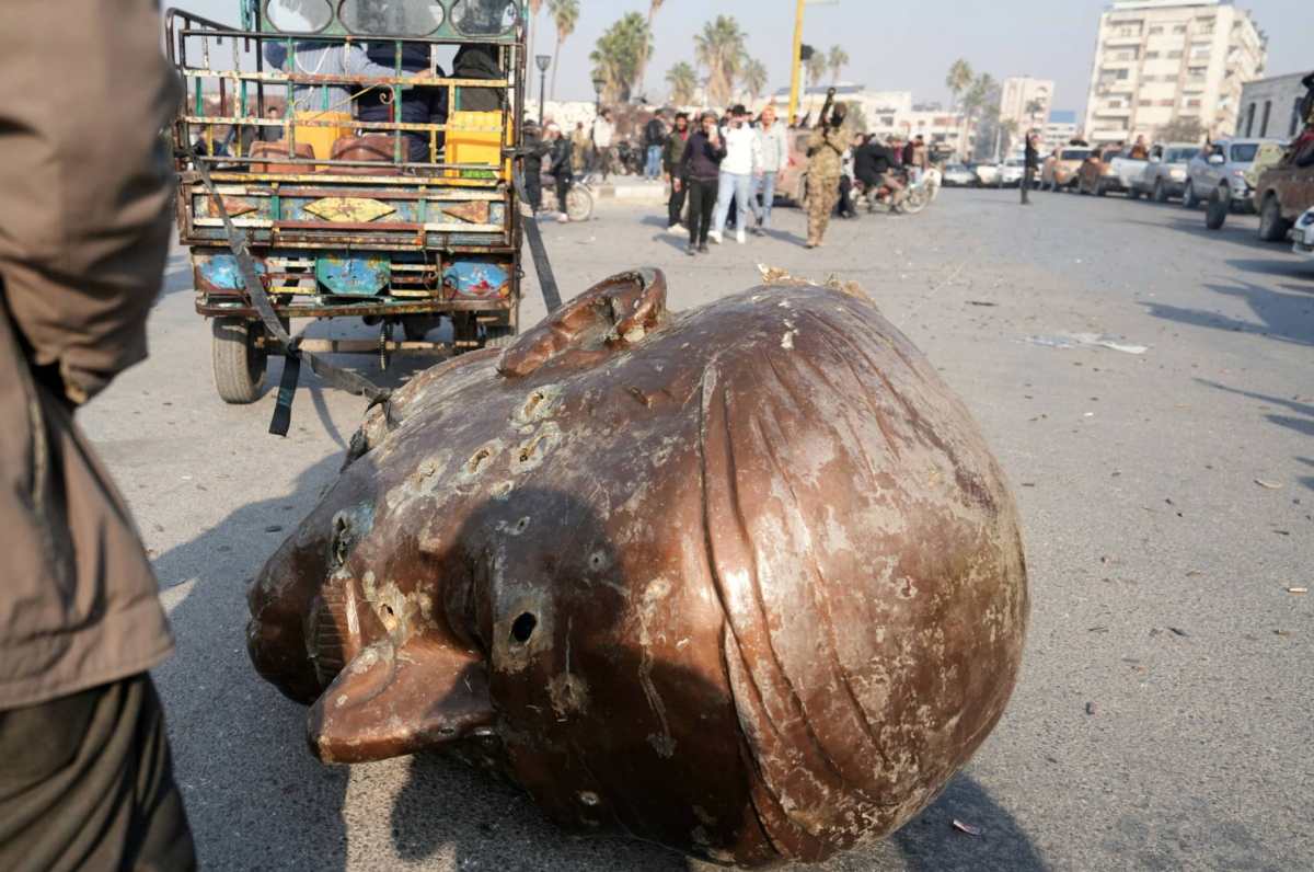 Protesters topple statue of Hafez al-Assad in Damascus suburb Protesters topple statue of Hafez al-Assad in Damascus suburb