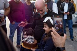 Souheil Hamawi is presented with a cake by his grandchildren in Chekka, northern Lebanon on Dec. 9, 2024, after spending 33 years in a Syrian prison. (Credit: Ibrahim Chalhoub/AFP)