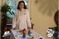 Yasmine Moufti posing in front of the table prepared ahead of her event, "No Play with Food." (Credit: Image provided by Yasmine Moufti)