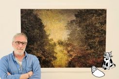 François Sargologo posing in front of a panel from his photographic series titled "The End of Romanticism" at the Janine Rubeiz Gallery. Courtesy of the artist and the gallery.