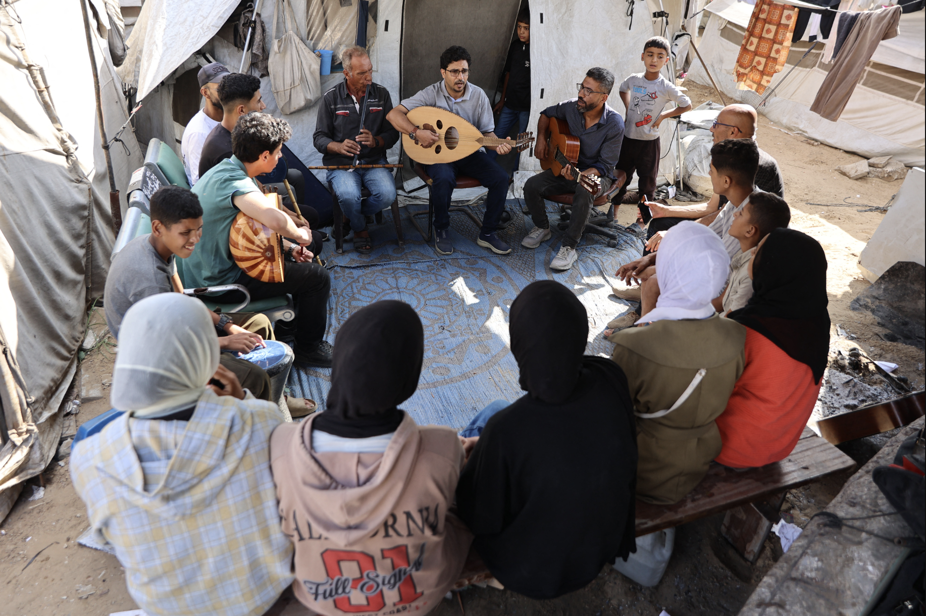 Some of Gaza's music teachers were students at the enclave's music conservatories whose studies were interrupted by the ensuing war. Some of them spoke of how hard it was to find time to practice their art when all around them is chaos, but how every time they did, it brought them some peace. (Credit: Omar al-Qattaa/AFP)
