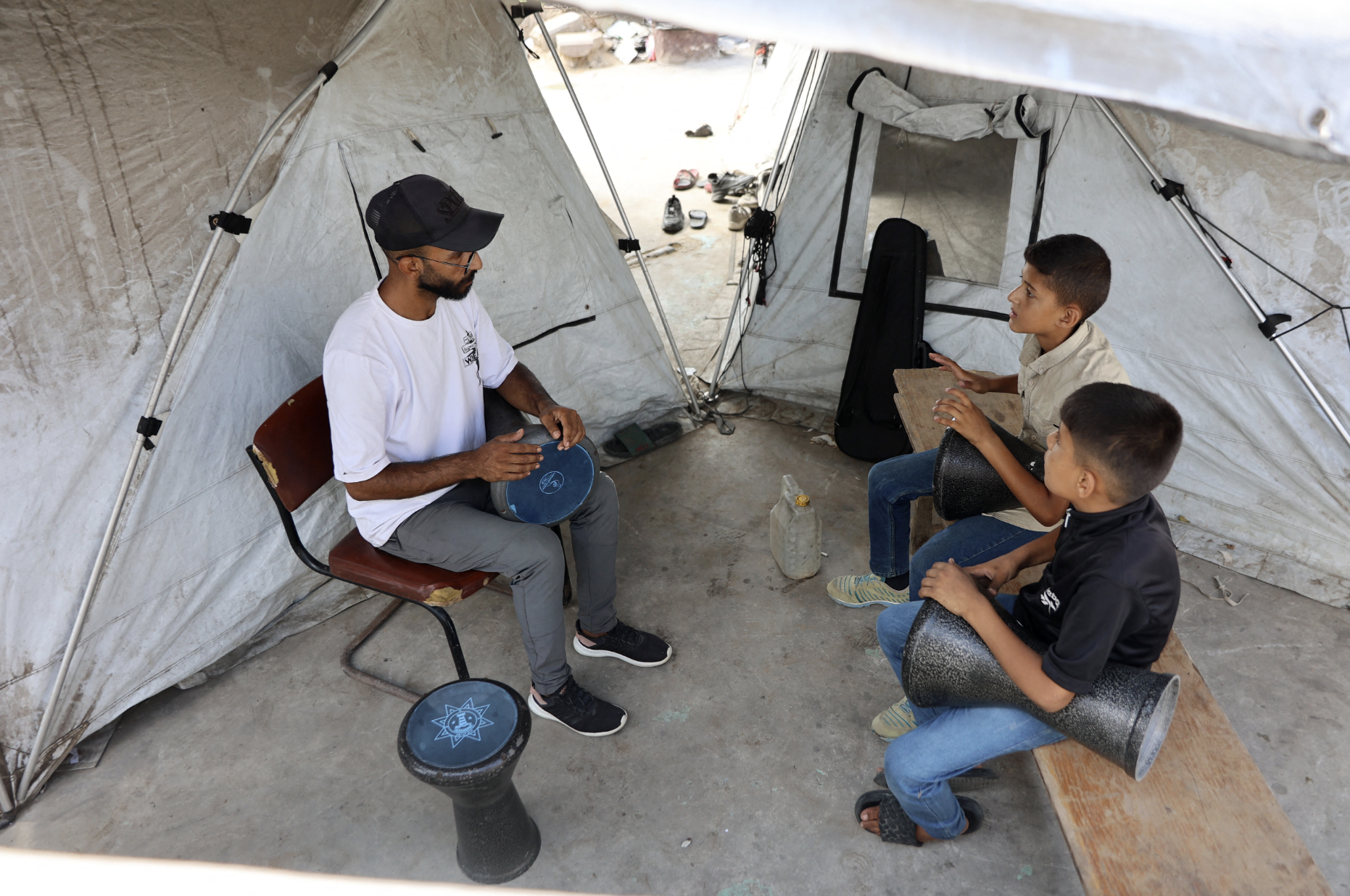 "Music releases sadness from ourselves, it makes me feel happier," one young Gazan boy told Al Jazeera last September. With a big smile on his face he says: "The choir was singing and it brightened my day a bit." (Credit: Omar al-Qattaa/AFP)