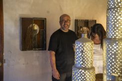 Alfred Tarazi with his perforated perfume containers, welded into the shape of a fortified city. (Photo courtesy of the artist)