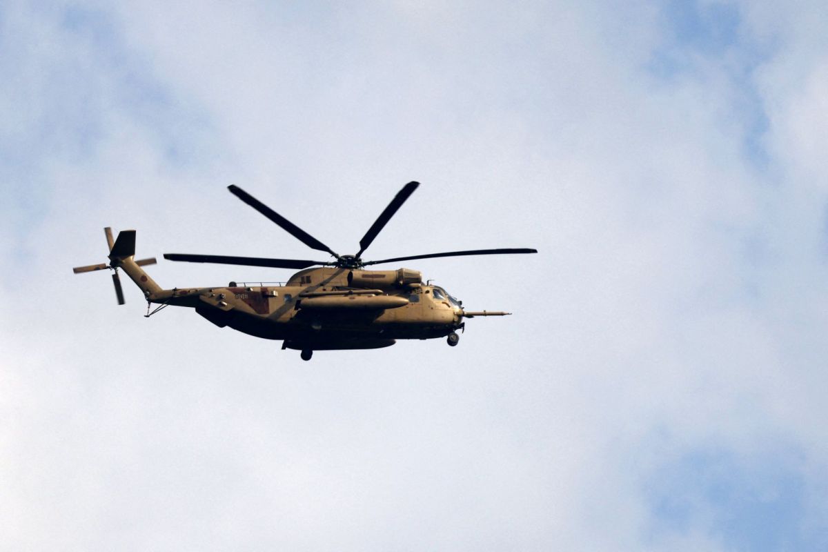 Leaflets dropped by Israeli helicopter during funeral of Amal official