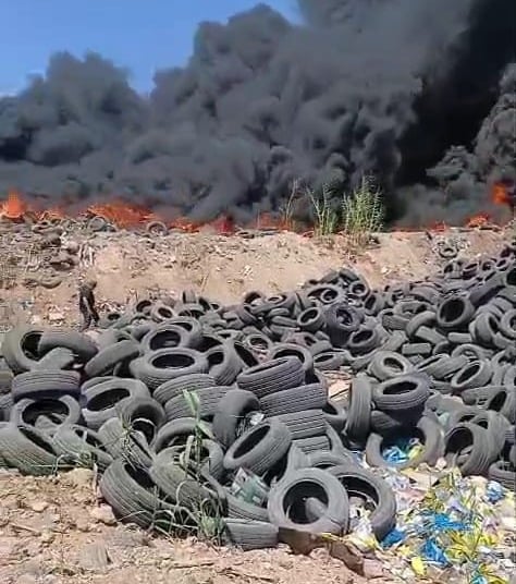 Tripoli covered by a black cloud of burning tires