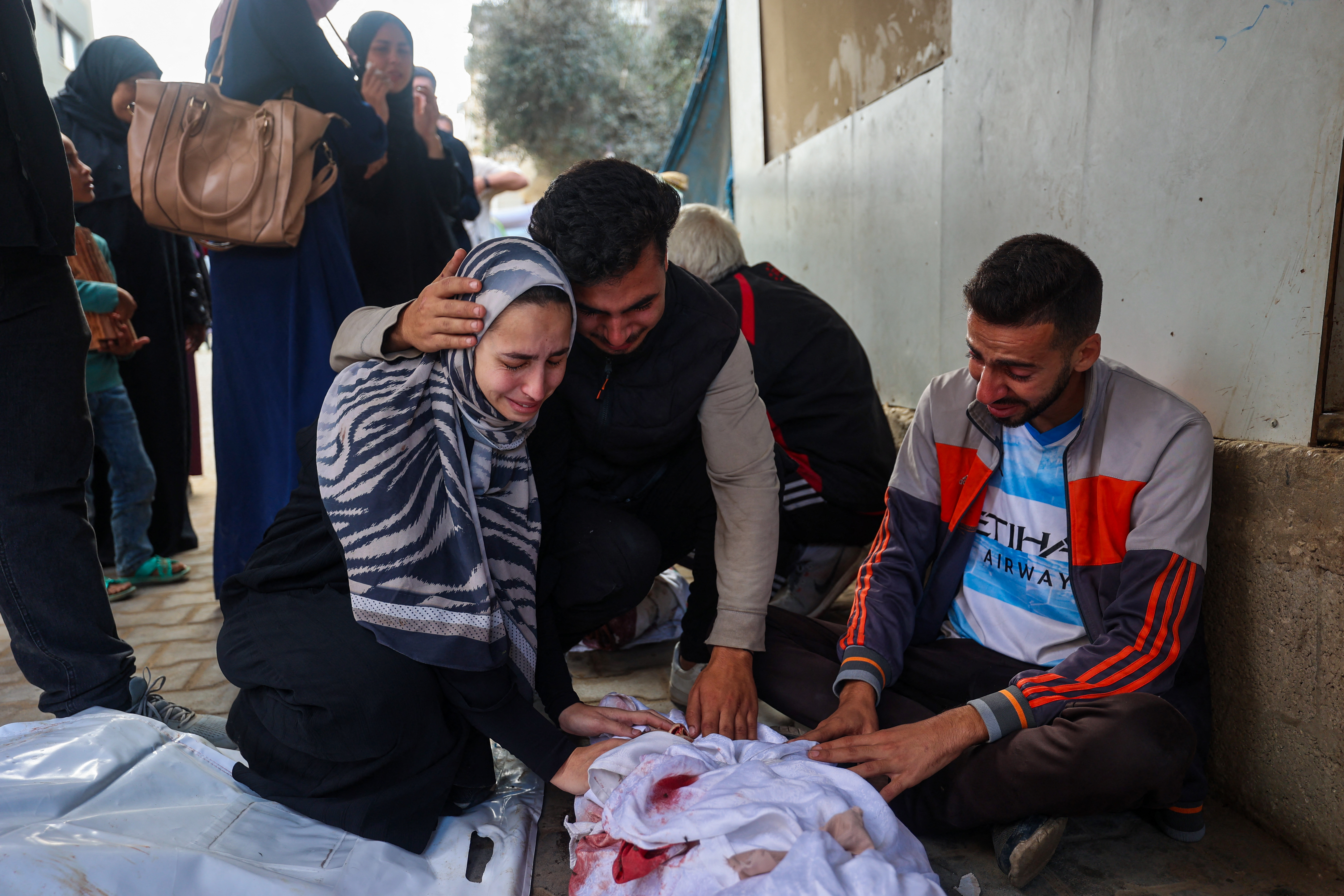 A family mourns their child who was killed in an Israeli strike, Oct. 29, 2025. (Credit: Eyad Baba/AFP)