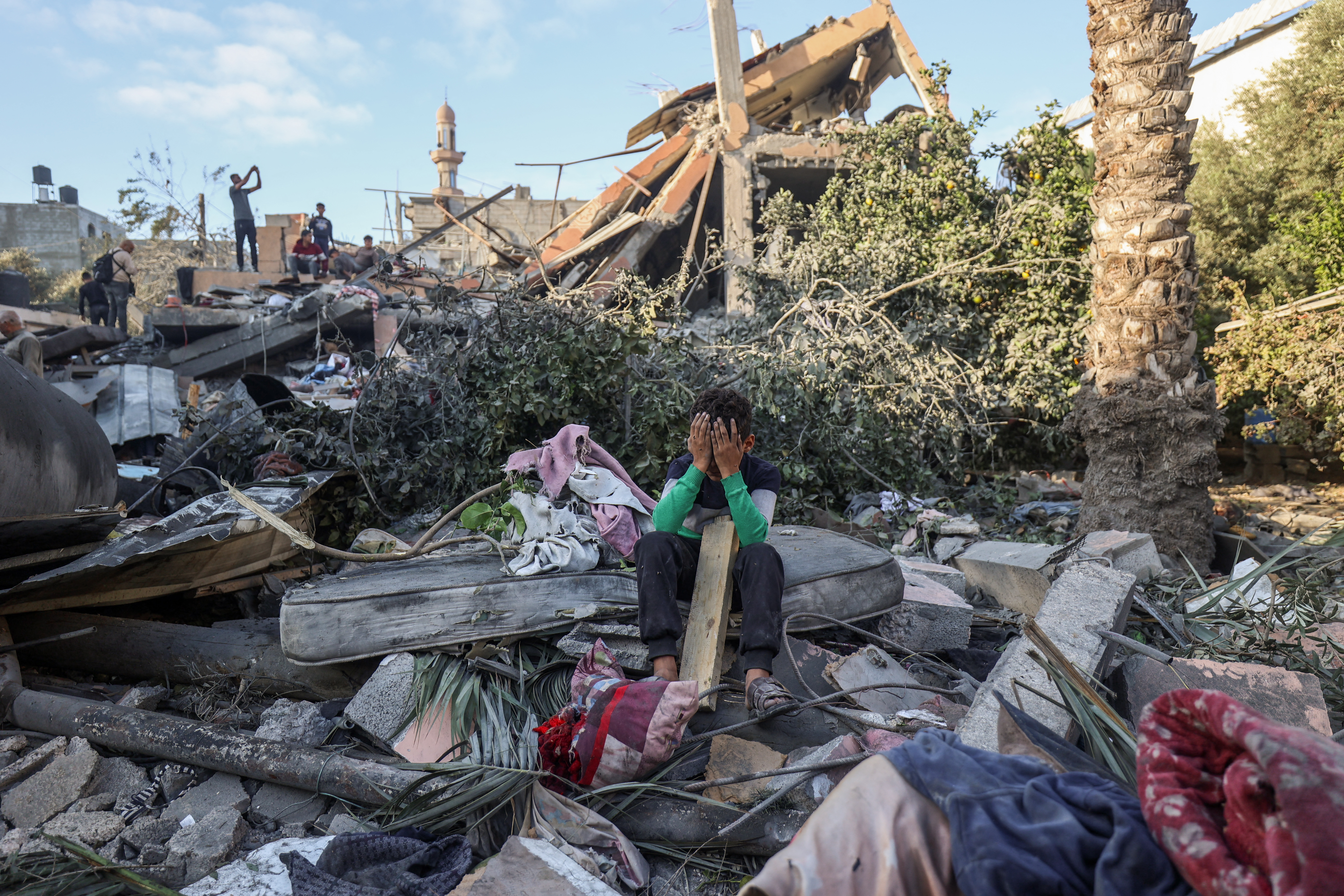 A child sits amid the rubble of a house destroyed in an Israeli strike in Nusseirat, central Gaza Strip, Oct. 29, 2025. (Credit: Eyad Baba/AFP)