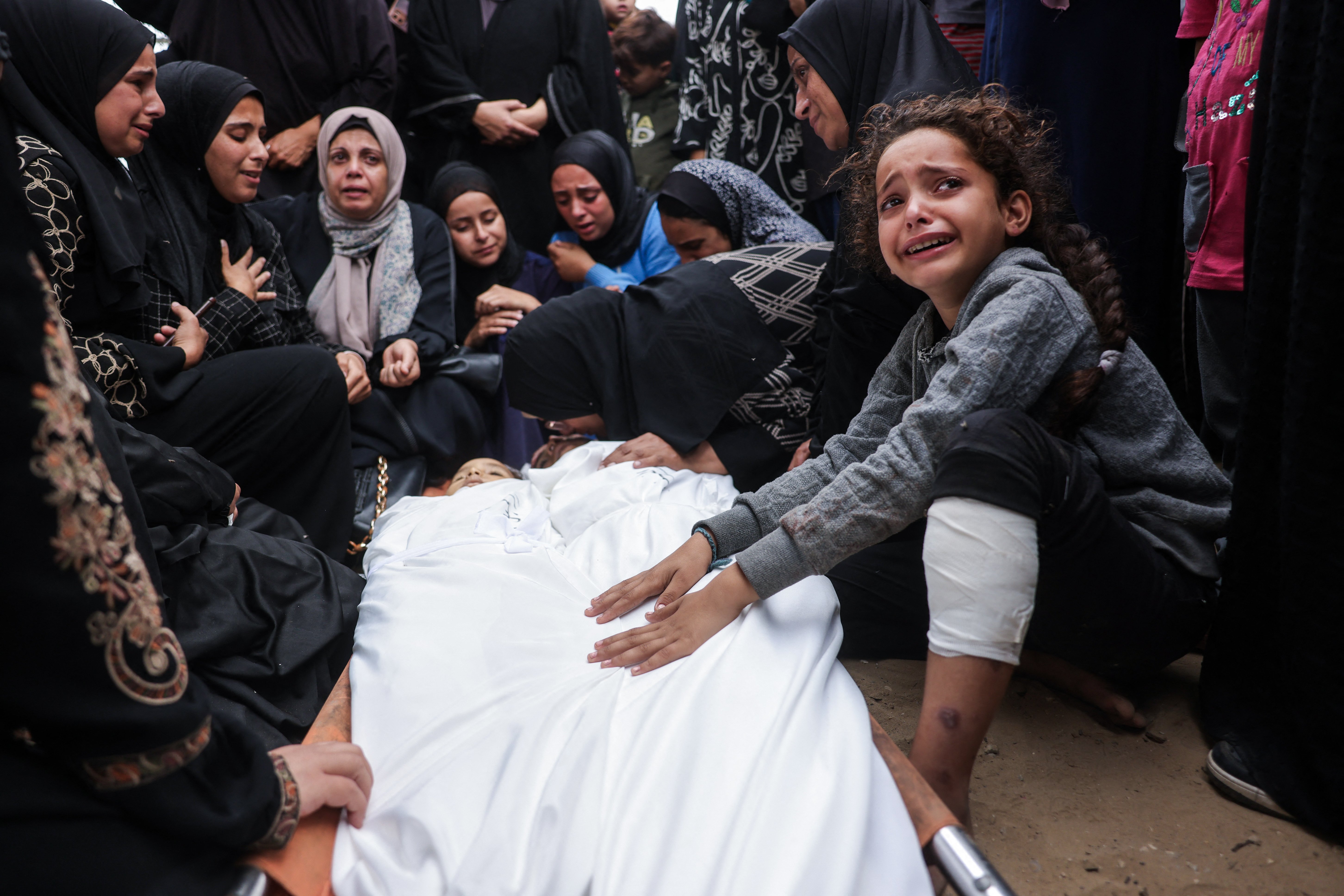 A family mourns two children killed in an Israeli strike at Nasser Hospital in Khan Younis, southern Gaza Strip, Oct. 29, 2025. (Credit: Bashar Taleb/AFP)
