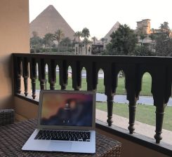 Image taken by designer Tarek Atrissi in front of his computer, with the Pyramids of Giza outlined on the horizon. (Credit: Tarek Atrissi)