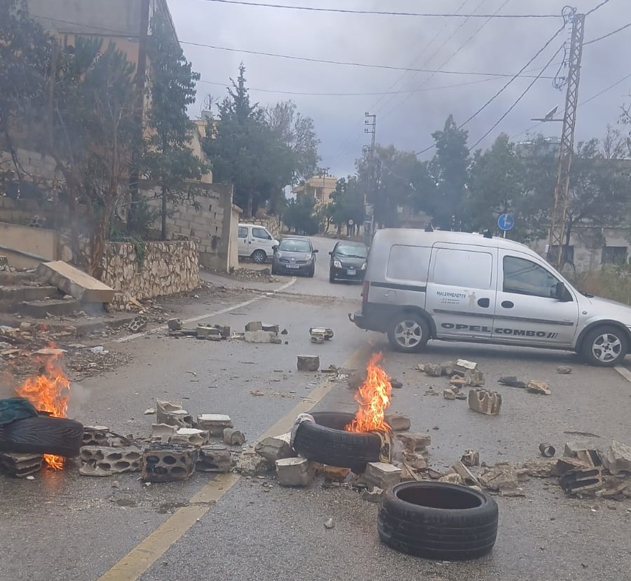 Israeli fire on Kfar Shuba, a Deir Siryan
resident blocks a road