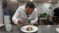Alan Geaam finishes plating his mushroom velouté with a fried egg on a bed of sautéed mushrooms. Photo Aly Balbacky
