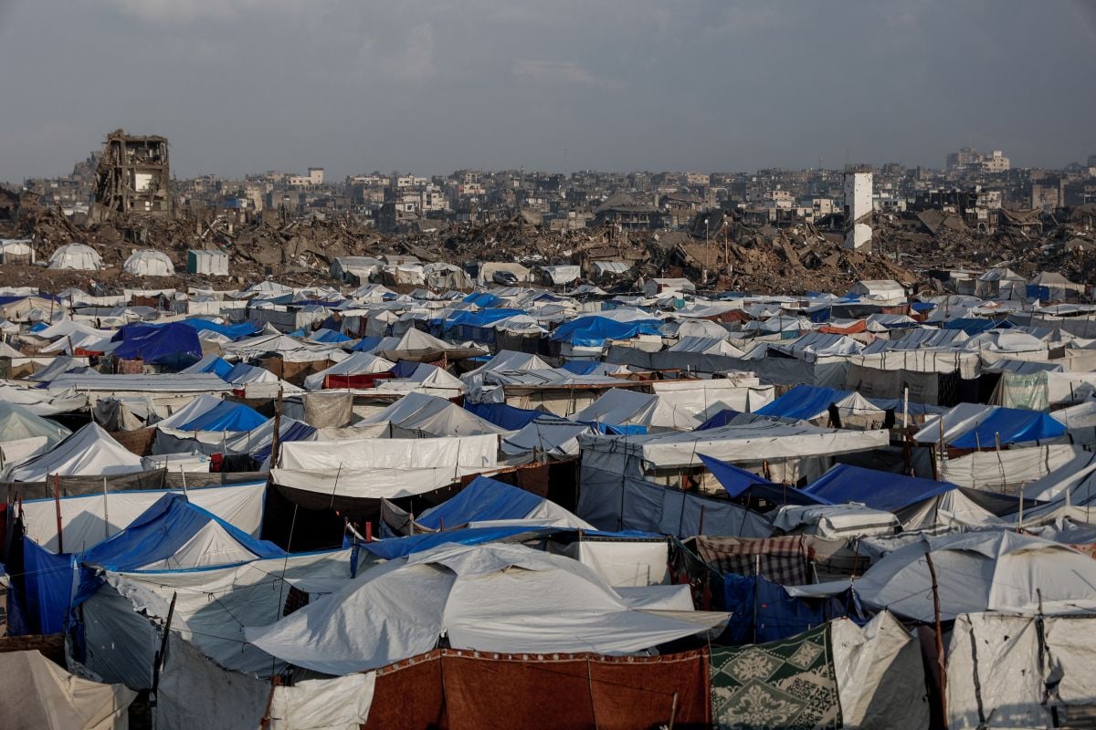 Desperate Palestinians dig out iron bars from the rubble for shelter and meagre income