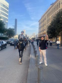 A young man taking a selfie with and ISF officer on a horse in Downtown Beirut. (Credit: @LebISF/X) 