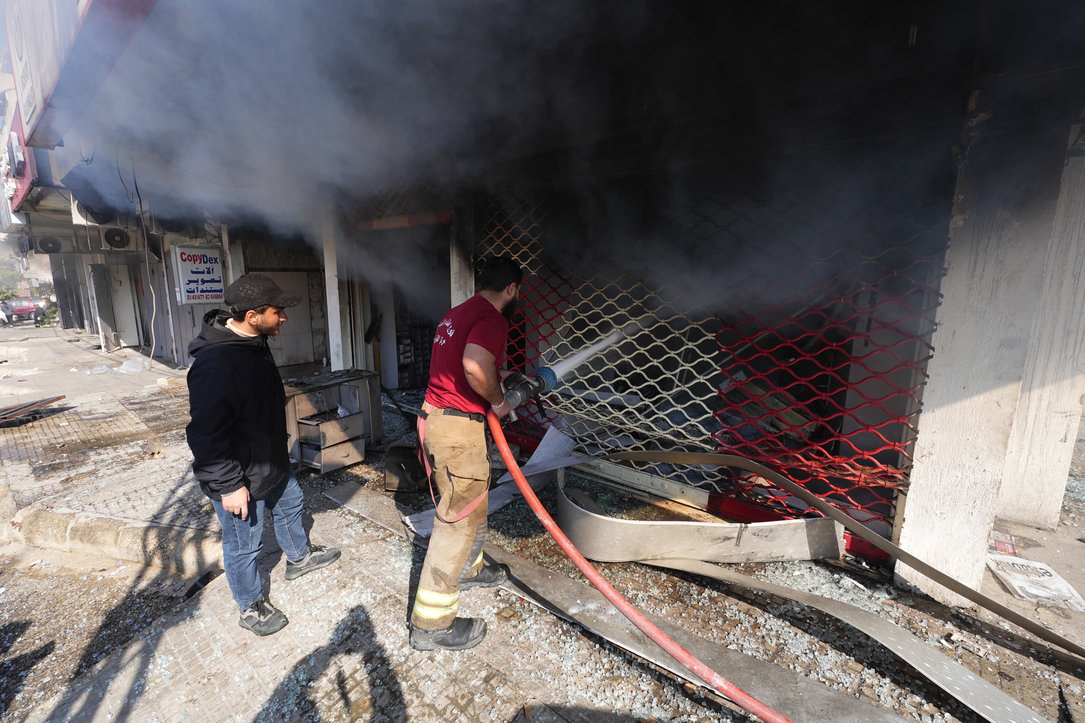 Despite the risk of further strikes, volunteers came to extinguish fires ravaging shops and homes. (Credit: Mohammad Yassine/L’Orient Today)