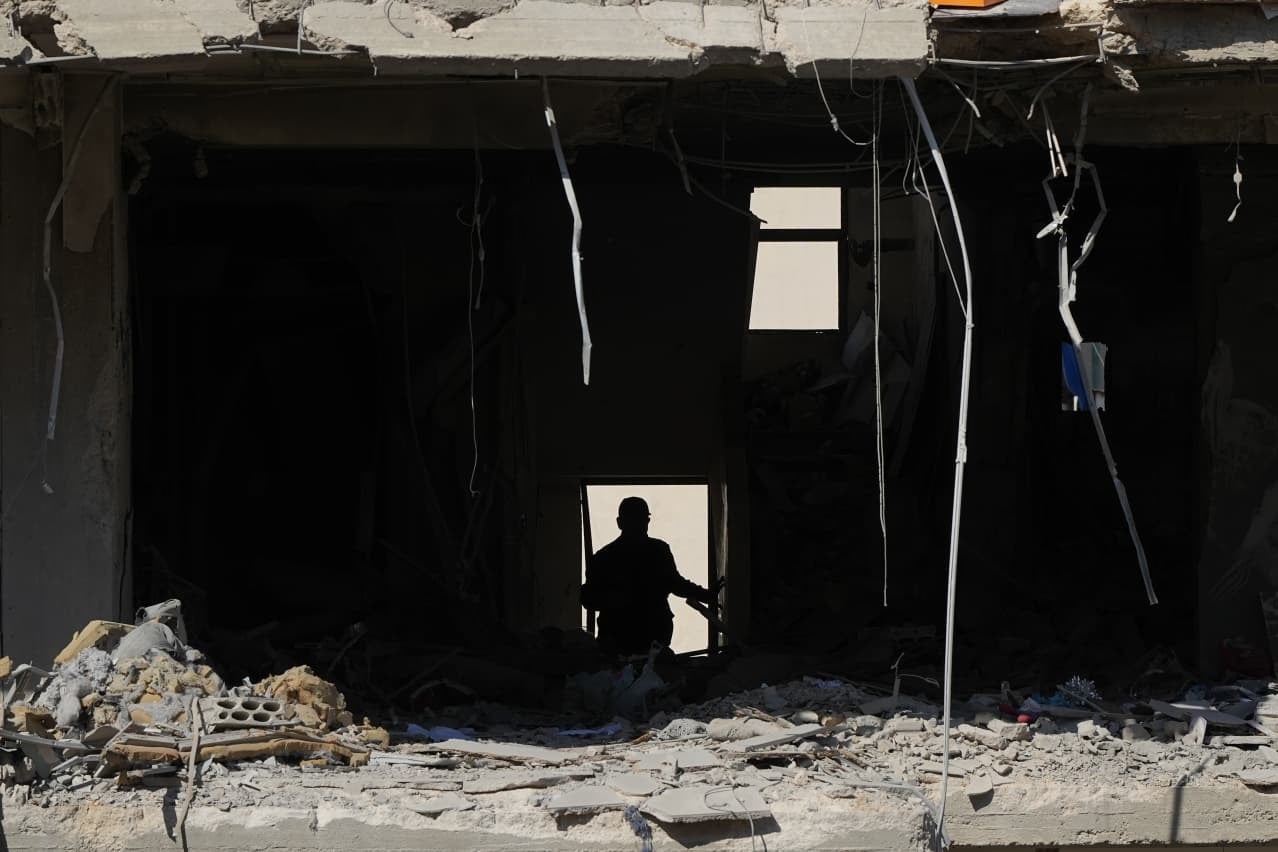 A man inspects the destruction in one of the apartments hit by the Israeli strike. (Credit: Mohammad Yassine / L’Orient Today)
