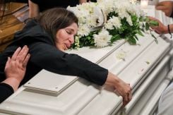 La mère de Théodosia et Tony Karam, tués avec leur père James dans une frappe israélienne, enlaçant un de leur cercueil lors de funérailles à Qlayaa, le 3 juin 2026. Photo REUTERS/Stringer