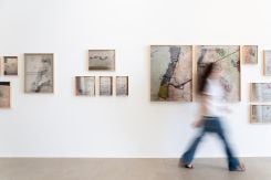 A silhouette in front of the lachrymal work that gives its title to the exhibition "As I Weep" by Lamia Joreige at the Marfa' gallery. (Credit: Youssef Itani/Studio Tajareb)