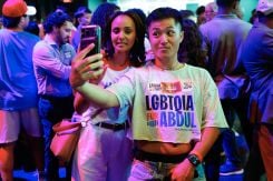 Attendees pose for a selfie during Democratic US Senate candidate Abdul El-Sayed's election night event at The Majestic Theater in Detroit, Michigan, on Aug. 4, 2026. (Credit: Jeff Kowalsky/AFP)