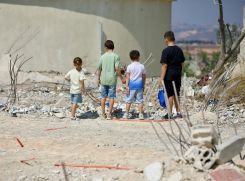 Des enfants déplacés observent ce qui reste d’une école détruite par les bombardements israéliens, le 2 septembre 2026 dans le village de Bourj Qalaouay au Liban-Sud, lors d’une tournée de la ministre de l’Éducation, Rima Karami. Photo Matthieu Karam/L’Orient-Le Jour