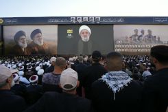 A crowd watches Hezbollah leader Naim Qassem’s speech, broadcast on a giant screen in Beirut’s southern suburbs, during a commemoration marking the anniversary of Hassan Nasrallah’s assassination, Sept. 27, 2026. (Credit: Mohammad Yassine/L’Orient-Le Jour)