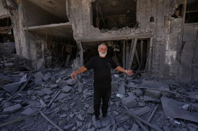 A Nabatieh resident gestures to indicate the extent of the damage in his city